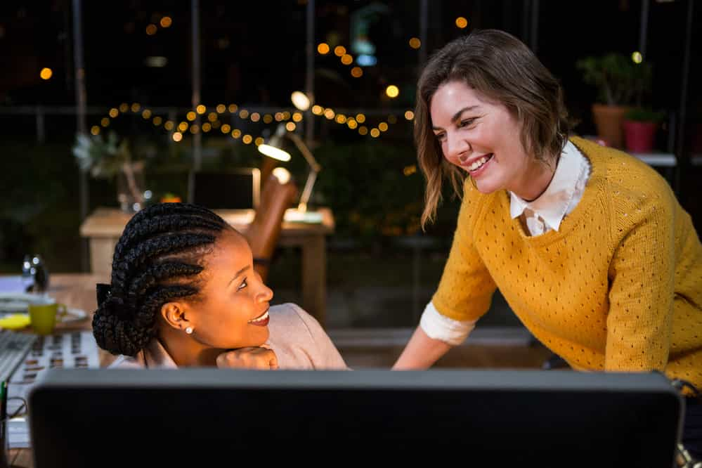 Businesswoman interacting with colleague in the office